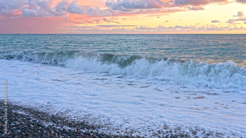 Seascape with waves and pink sunset