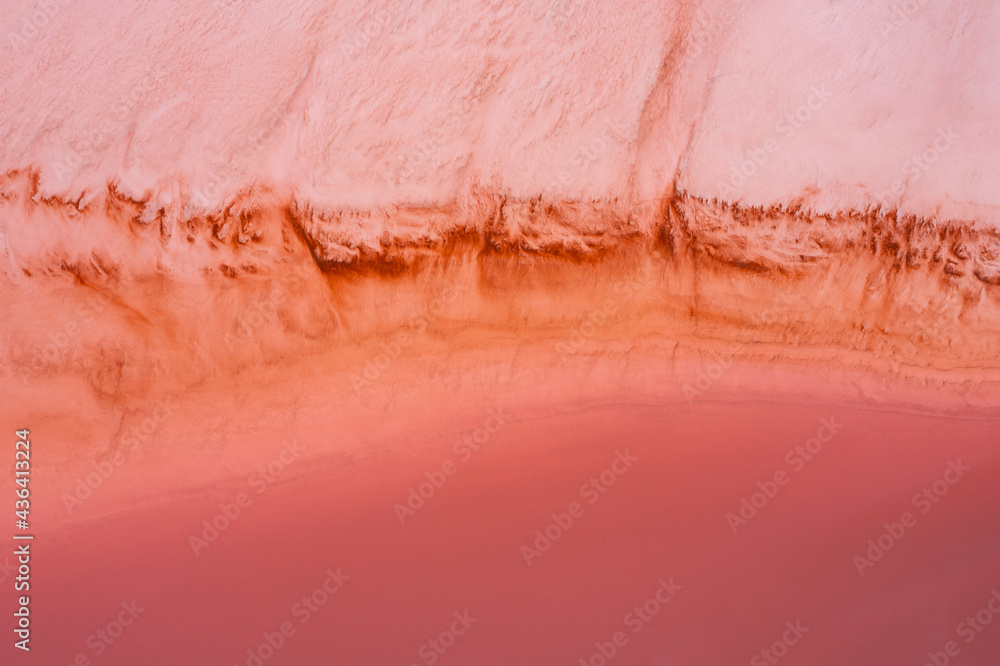 Fototapeta premium Aerial view of sections at Hutt Lagoon or Pink Lake near Port Gregory in Western Australia, Pink color created naturally by bacteria and harvested in ponds for beta-carotene