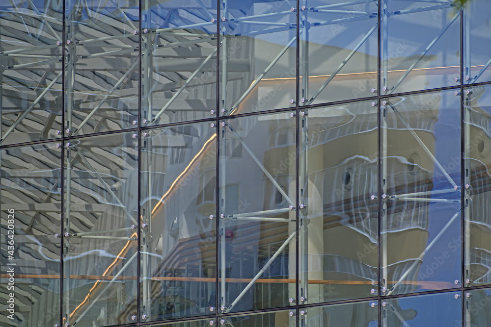 A fragment of the glass wall of a building under construction close-up