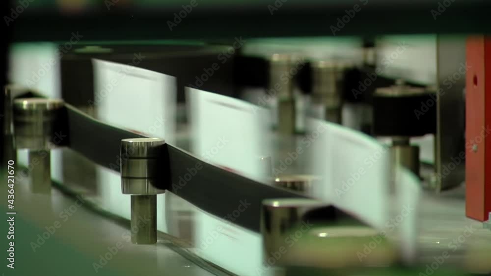 A Machine for Automatic Sorting of Mail Items is processing a Large Batch of Letters. Closeup. A Machine for Automatic Sorting of Mail Items is processing a Large Batch of Letters. Closeup.