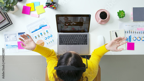 Overhead top view young asian woman employee work from home using computer notebook videocall meeting conference angry annoy with low poor unreliable internet wifi connection problem issue outage.