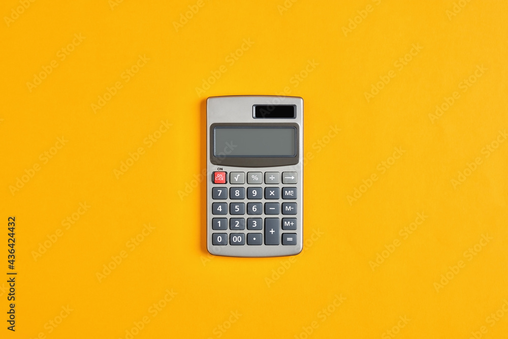Calculator on yellow background. Calculation in business, finance or education Calculator on yellow background. Calculation in business, finance or education