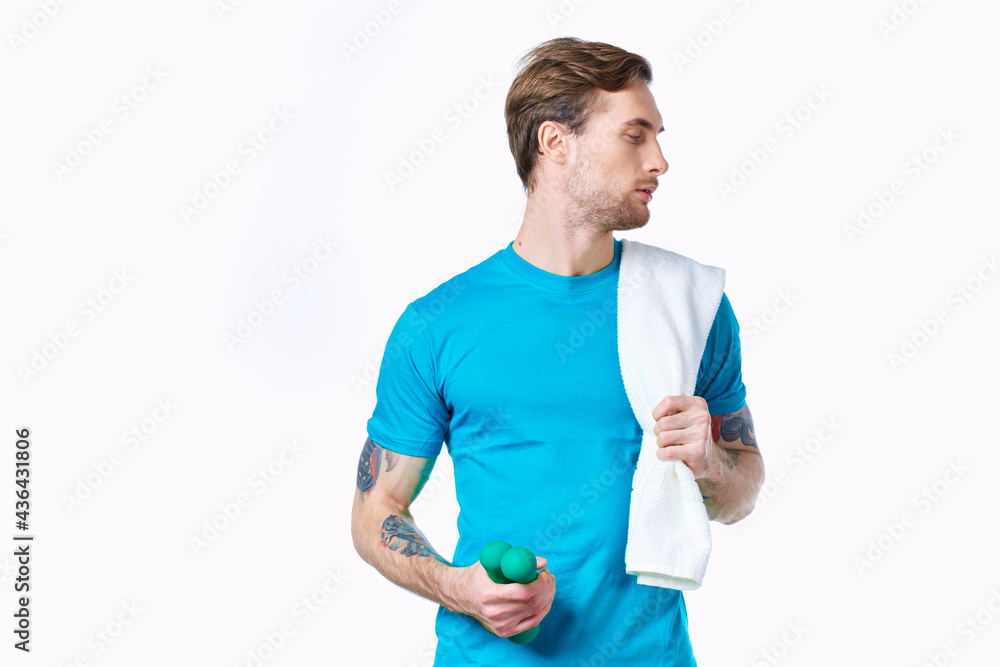 man with dumbbells in hands towel on shoulder workout fitness light background man with dumbbells in hands towel on shoulder workout fitness light background