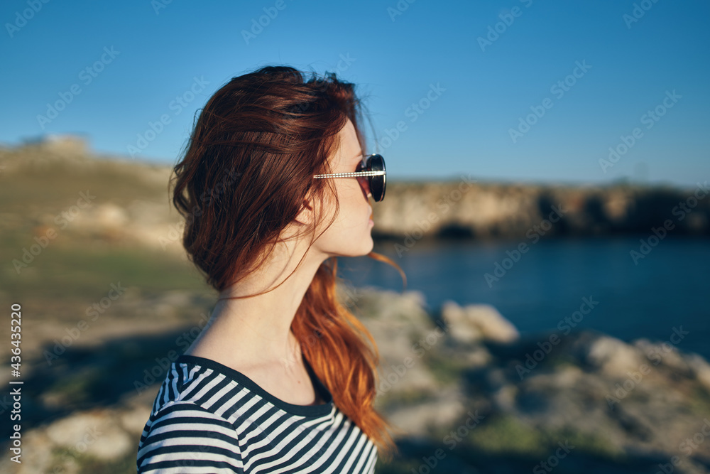 portrait of a woman in the mountains outdoors in summer t-shirt glasses landscape