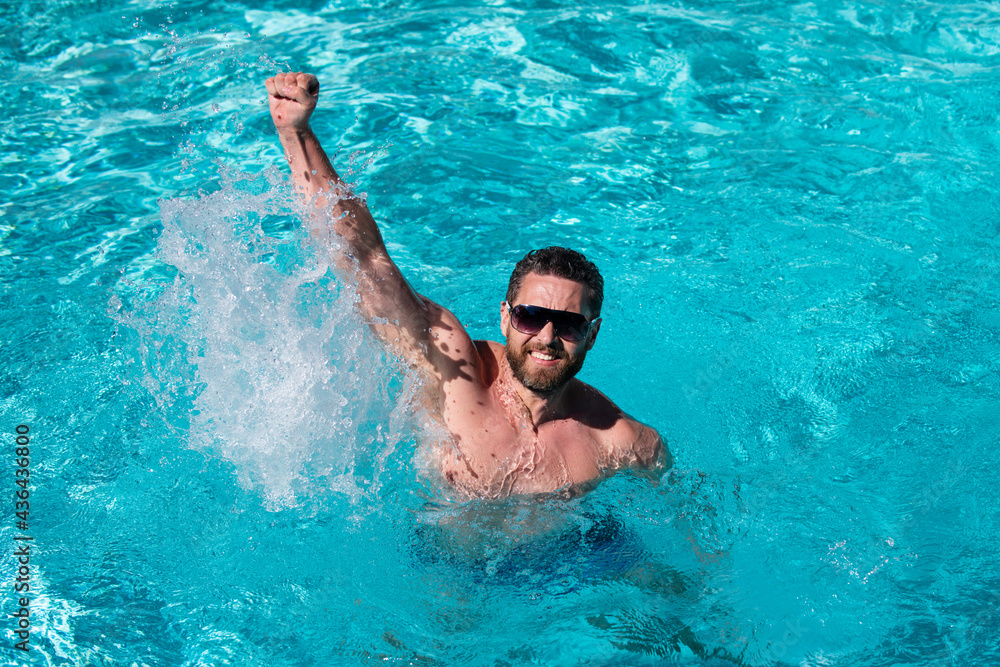 Pool resort. Excited man in pool. Summertime vacation. Summer man.
