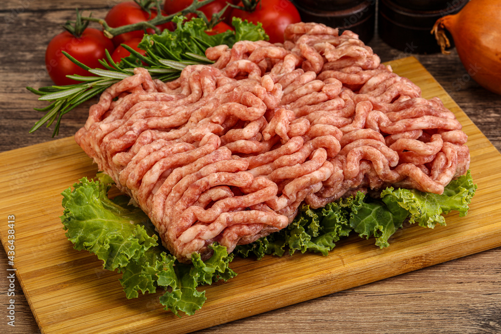 Raw pork minced meat over board Raw pork minced meat over board