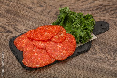 Italian spycy pepperoni sausage slices photo