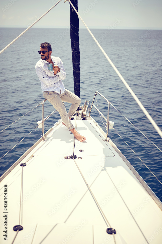 Casual sexy man sailing alone; Luxurious lifestyle concept