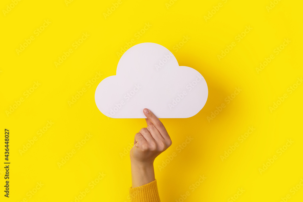 cloud in hand over yellow background, storage concept cloud in hand over yellow background, storage concept