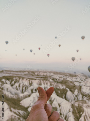love sign hand to the sky with balloons