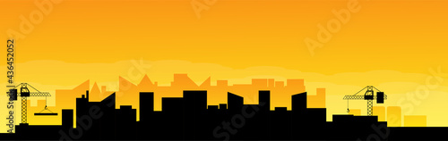 Panorama of Industrial City on Cloudy Sunrise with Construction Site in the Morning Haze