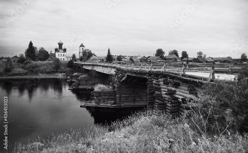 Old bridge across the river to the village of Izmailovskaya Arkhangelsk region