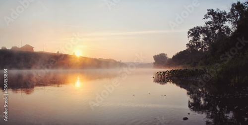 Fototapeta Naklejka Na Ścianę i Meble -  Sunset over a wide river on a summer evening
