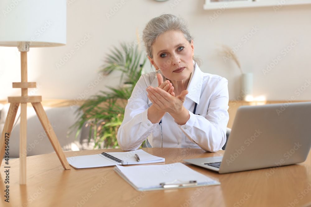 Older woman doctor therapist wearing headset video call talking to web camera consulting virtual patient online by video conference call chat. Older woman doctor therapist wearing headset video call talking to web camera consulting virtual patient online by video conference call chat.