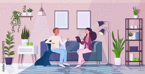 man with psychologist sitting on sofa psychotherapist consulting patient during psychotherapy session