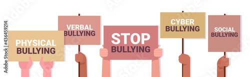mix race activists hands holding stop bullying banners social anxiety psychotherapy concept