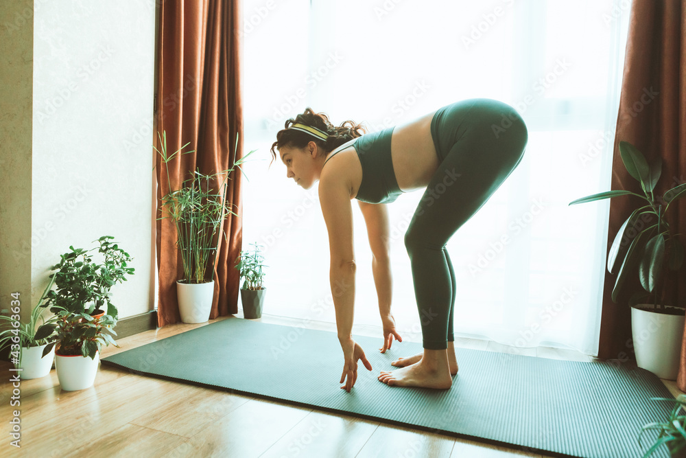 woman do yoga at home near big window woman do yoga at home near big window