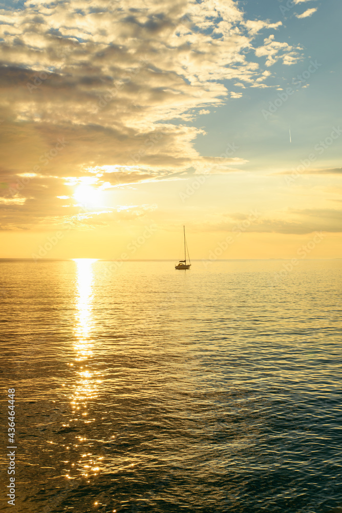 view of sail boat on sunset in bay. summer vacation