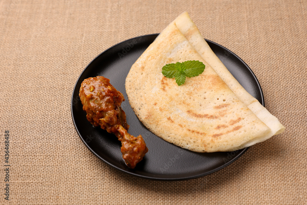 Dosa , Dosai, ghee roast with chicken curry popular South Indian