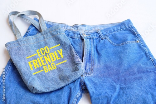 Text " Eco friendly bag" on handmade bag made of old jeans. Concept DIY. Reuse and recycle for environment.
