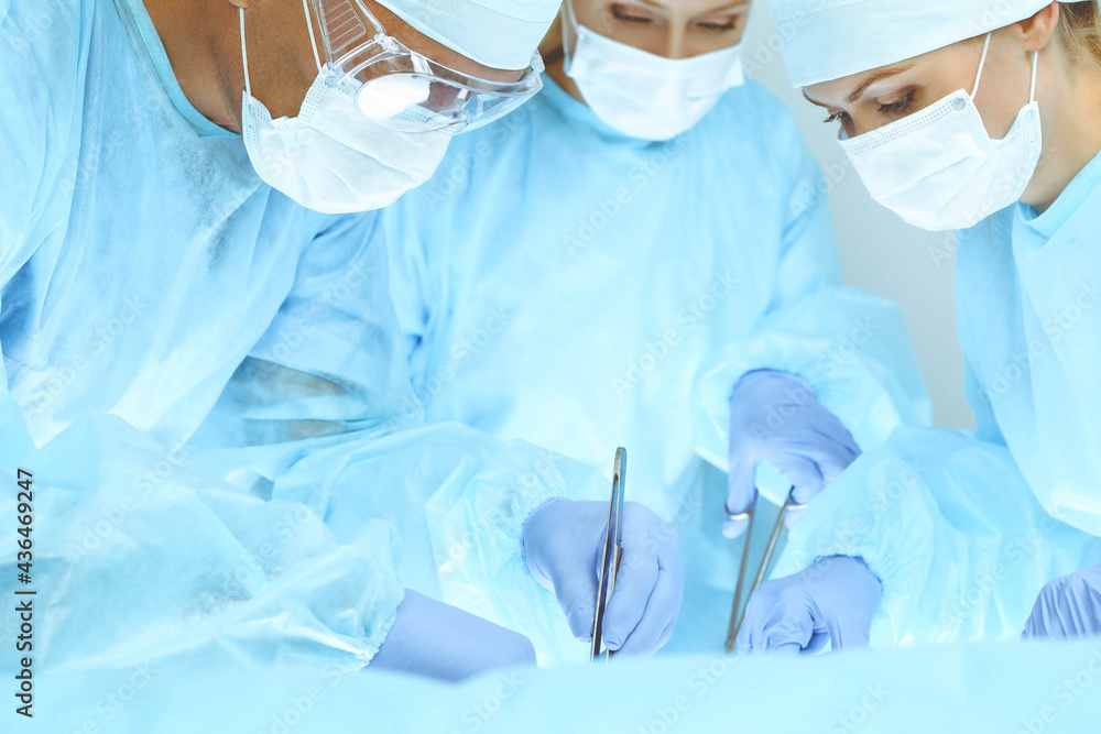 © rogerphoto - A group of surgeons is operating at the hospital. Health care concept