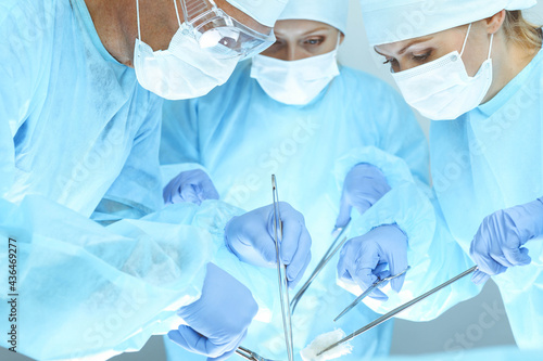 A group of surgeons is operating at the hospital. Health care concept