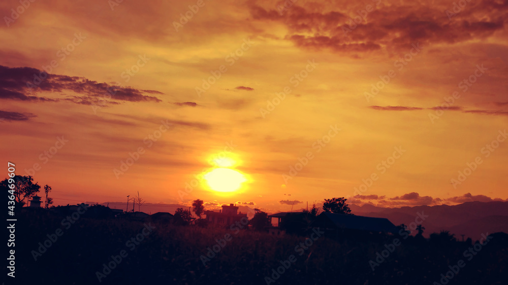 Naklejka premium Beautiful image of sunset in the mountains and clound in the sky with orange and red colour tone.