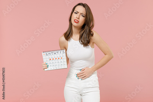 Photography Young suffering woman in white clothes hold in hand female periods calendar chec