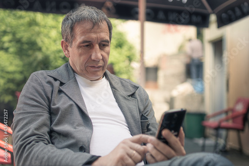 man using smartphone in cafe © larisikstefania