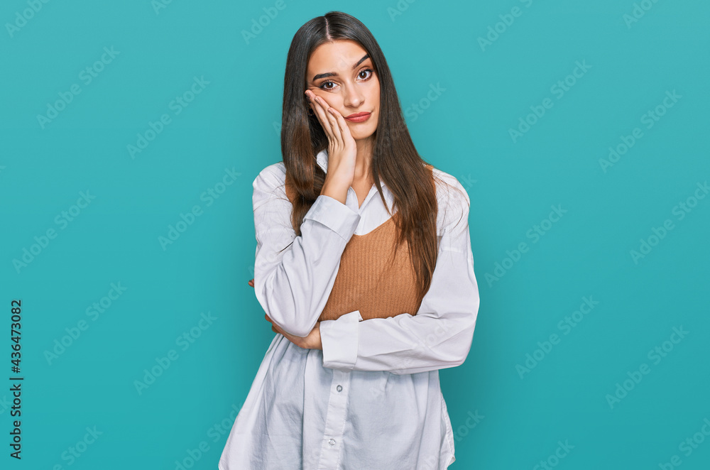 Young beautiful woman wearing casual white shirt thinking looking tired and bored with depression problems with crossed arms. Young beautiful woman wearing casual white shirt thinking looking tired and bored with depression problems with crossed arms.