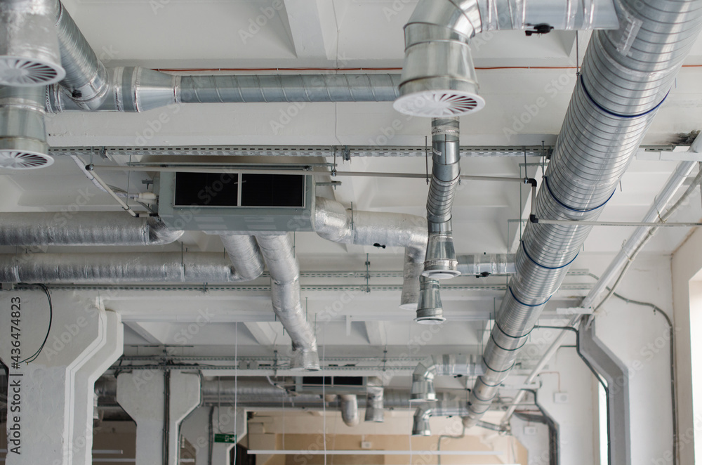 Air duct, air conditioner pipe on white ceiling wall. Ventilation system on  the ceiling of large building. Air condition and hvac system installation  under bareskin ceiling before interior finishing. Photos | Adobe