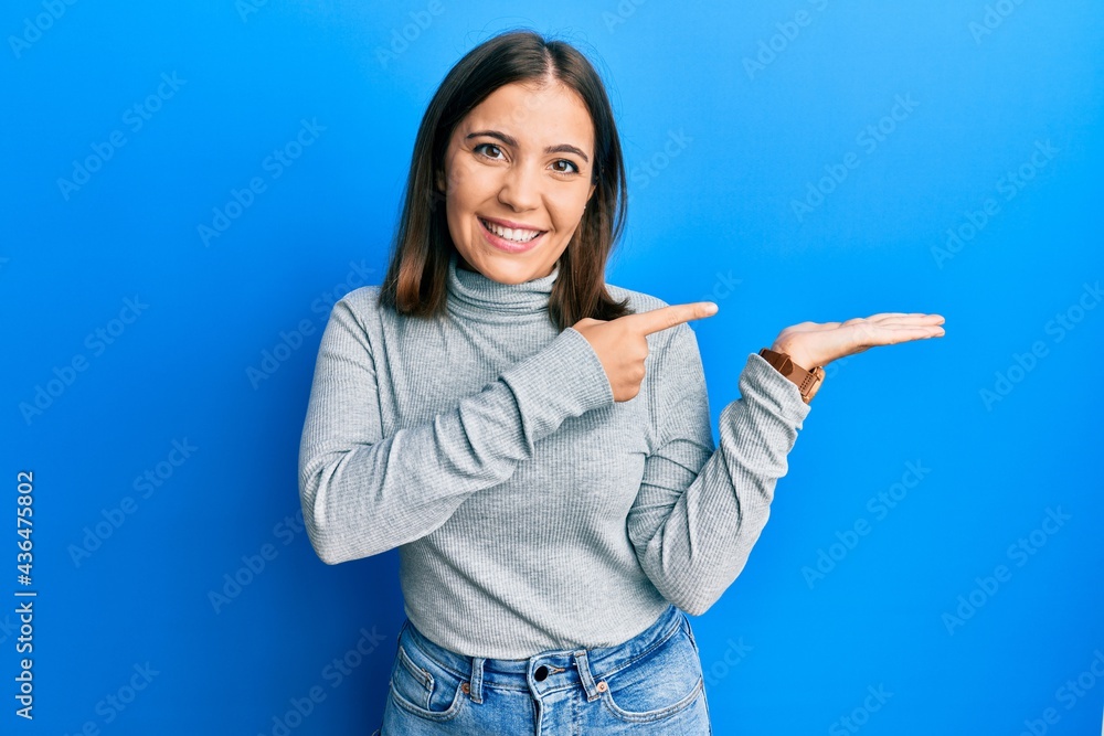 Young caucasian woman wearing casual turtleneck sweater smiling and looking at the camera pointing with two hands and fingers to the side. Young caucasian woman wearing casual turtleneck sweater smiling and looking at the camera pointing with two hands and fingers to the side.