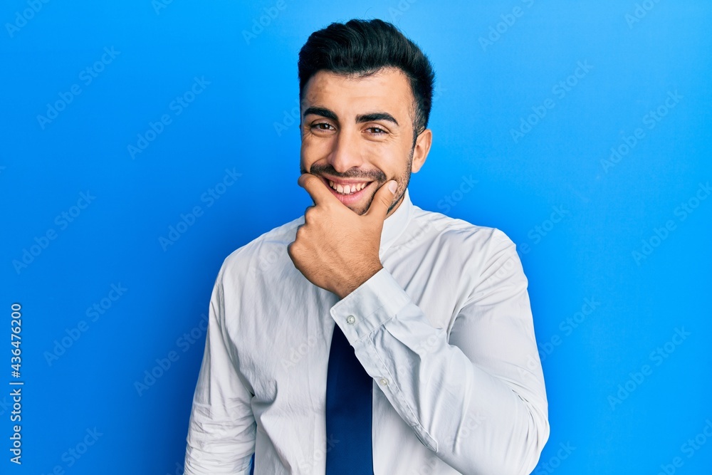 Young hispanic man wearing business clothes looking confident at the camera smiling with crossed arms and hand raised on chin. thinking positive. Young hispanic man wearing business clothes looking confident at the camera smiling with crossed arms and hand raised on chin. thinking positive.