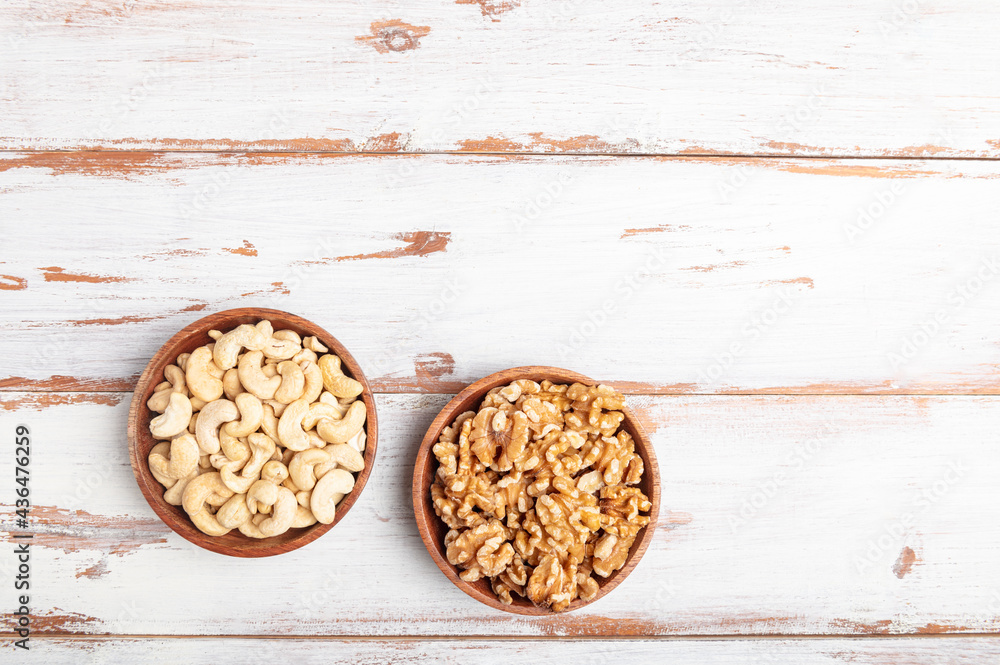 Cashew nuts and walnuts in wooden bowls