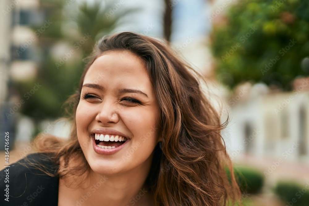 Young hispanic woman smiling happy standing at the city. Young hispanic woman smiling happy standing at the city.