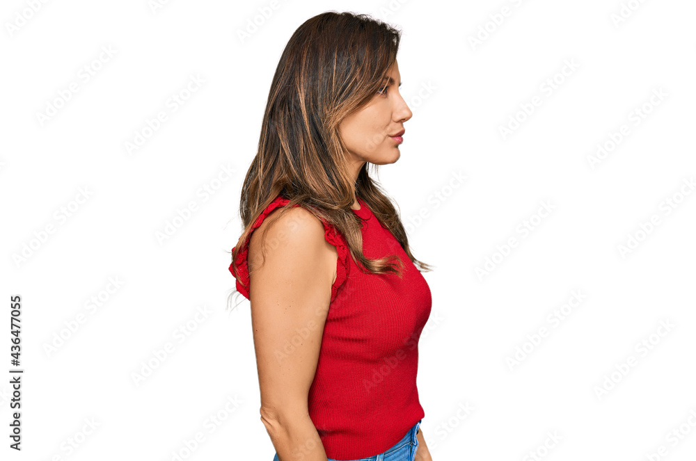 Young hispanic woman wearing casual clothes looking to side, relax profile pose with natural face with confident smile. Young hispanic woman wearing casual clothes looking to side, relax profile pose with natural face with confident smile.