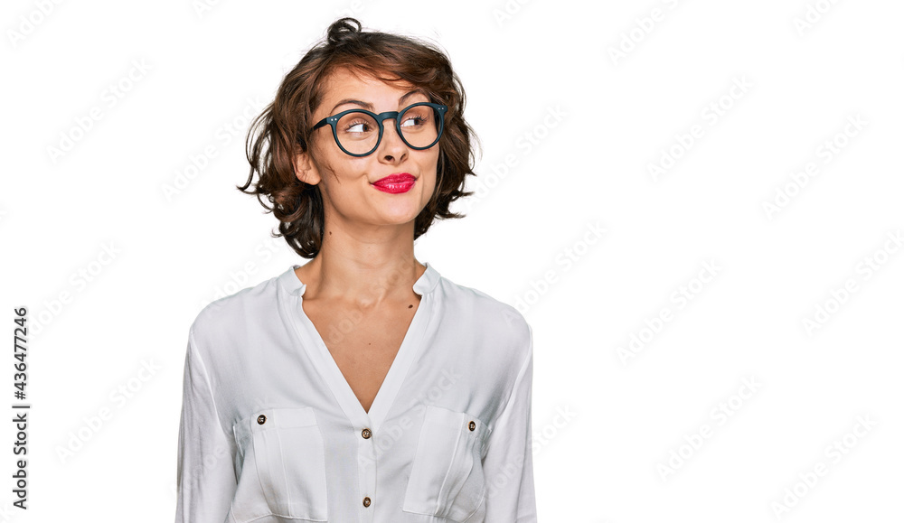 Young hispanic woman wearing business style and glasses smiling looking to the side and staring away thinking. Young hispanic woman wearing business style and glasses smiling looking to the side and staring away thinking.