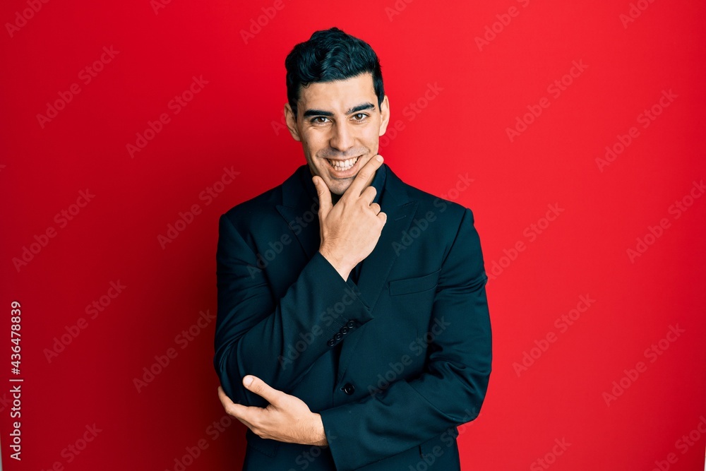 Handsome hispanic man wearing business clothes looking confident at the camera smiling with crossed arms and hand raised on chin. thinking positive. Handsome hispanic man wearing business clothes looking confident at the camera smiling with crossed arms and hand raised on chin. thinking positive.