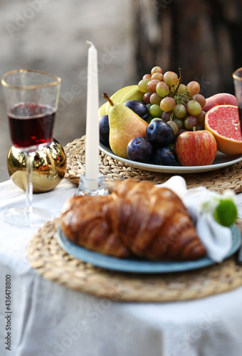 romantic picnic with croissants and fruits