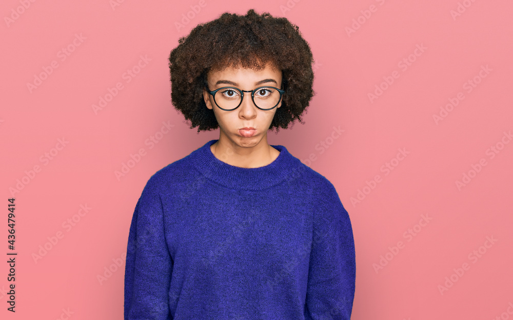 Young hispanic girl wearing casual winter sweater and glasses depressed and worry for distress, crying angry and afraid. sad expression. Young hispanic girl wearing casual winter sweater and glasses depressed and worry for distress, crying angry and afraid. sad expression.