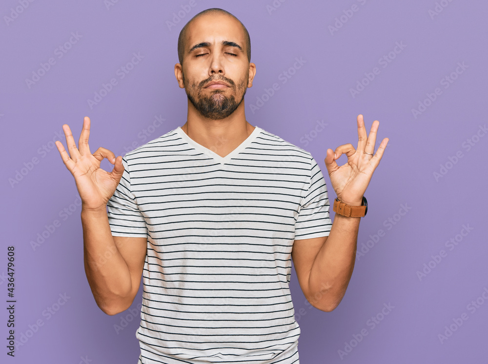 Naklejka premium Hispanic adult man wearing casual clothes relax and smiling with eyes closed doing meditation gesture with fingers. yoga concept.