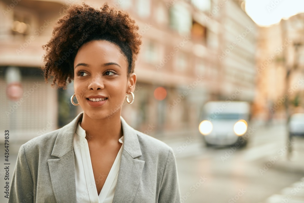 Young african american businesswoman smiling happy standing at the city. Young african american businesswoman smiling happy standing at the city.