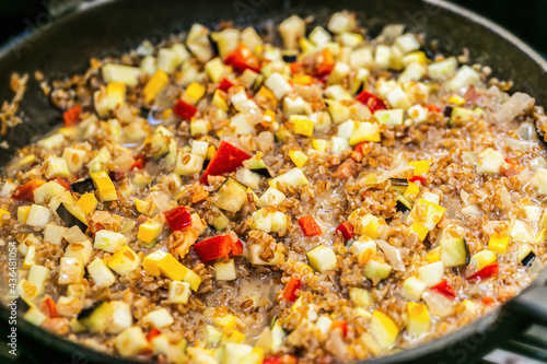 Bulgur with meat and vegetables in a pan. Close up