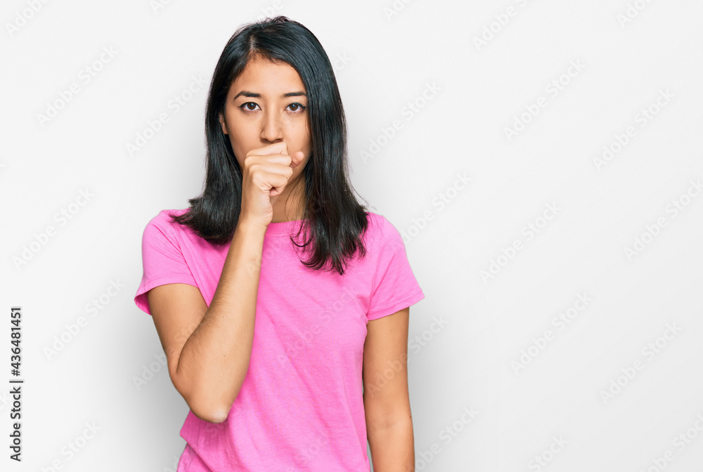 Beautiful asian young woman wearing casual pink t shirt feeling unwell and coughing as symptom for cold or bronchitis. health care concept. Beautiful asian young woman wearing casual pink t shirt feeling unwell and coughing as symptom for cold or bronchitis. health care concept.