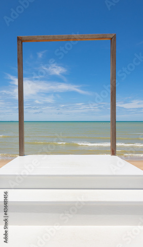 Ladder with steps to the wooden frame in front of clear and beautiful scenic view of blue sea and clear sky with horizon in tropical island shows art concept for path of success to heaven door.