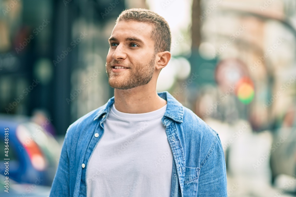 Young caucasian man smiling happy standing at the city. Young caucasian man smiling happy standing at the city.