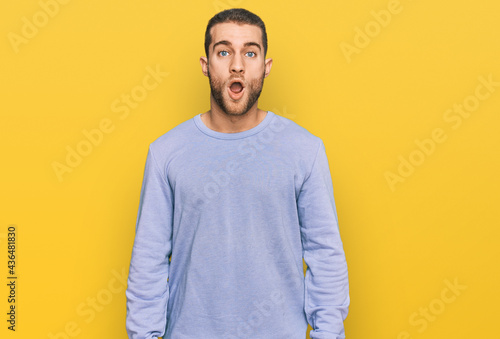 Young caucasian man wearing casual clothes afraid and shocked with surprise expression, fear and excited face.
