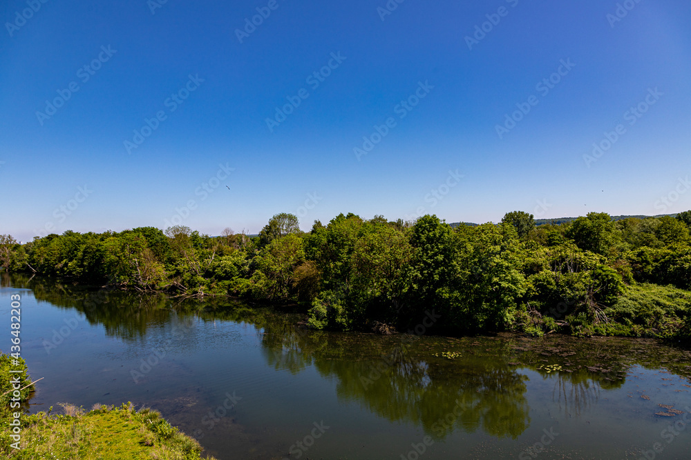 View over the river Meuse and the National park the Eijsder Beemden with beautiful reflections in the water. The river Meuse functions in this area as the border between Belgium and the Netherlands