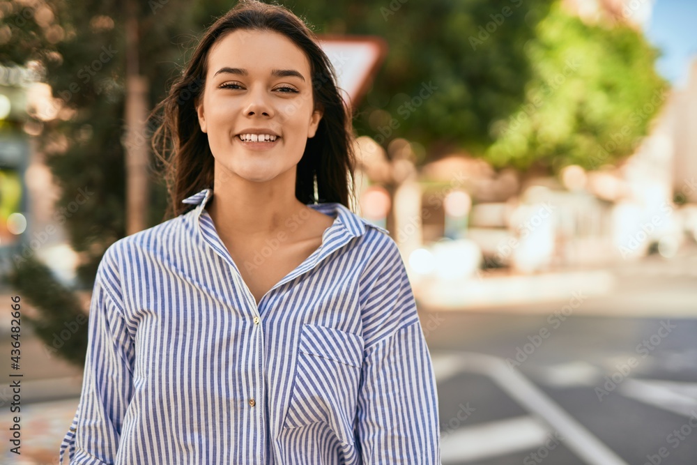 Young hispanic girl smiling happy standing at the city. Young hispanic girl smiling happy standing at the city.