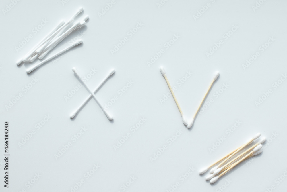 Ecological concept. Check mark made from wooden cotton swabs and cross made of plastic cotton swabs. Zero waste concept Ecological concept. Check mark made from wooden cotton swabs and cross made of plastic cotton swabs. Zero waste concept